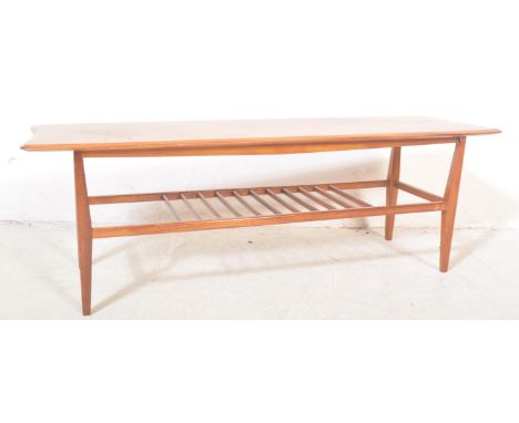 A vintage retro mid 20th century teak Ercol style coffee table. The coffee table having having a rectangular top with rail un