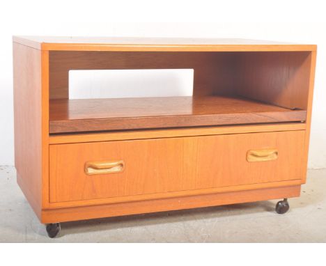 A vintage retro 1970's G Plan teak wood TV / entertainment unit having a central unit above over a single drawer with recesse