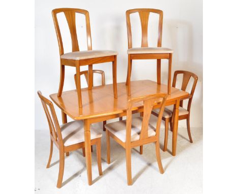 A vintage mid Century teak Meredew dining table and x6 chairs. The extending table of rectangular oval form together with x6 