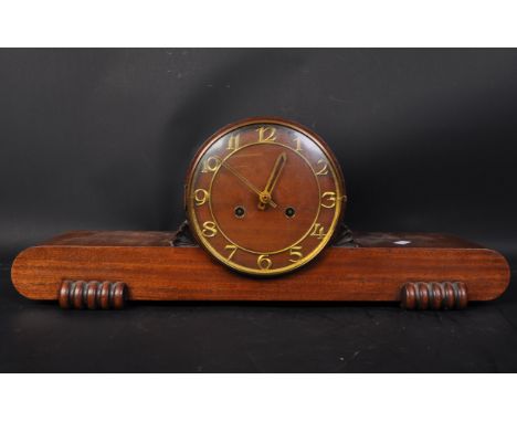 Art Deco 1920 / 1930s mahogany mantel clock . Having a round top with floral motifs to side, brass chapter ring with gilt num