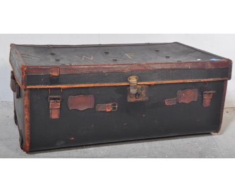 An early 20th century black leather steamer type travel trunk with white stencilled initials to lid and mounts to corners.&nb