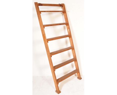 A 20th century vintage wooden ladder having metal hooks to top with vertical supports. Measures approx. 164cm x 65cm.