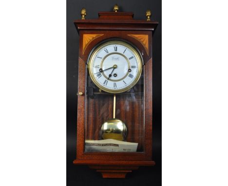 A late 20th century mahogany and glass cased Comitti of London Westminster chime wall mounted clock. The clock having a white