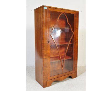 A vintage 20th century circa. 1940's Queen Anne revival walnut display cabinet having lattice type glazing to twin doors with