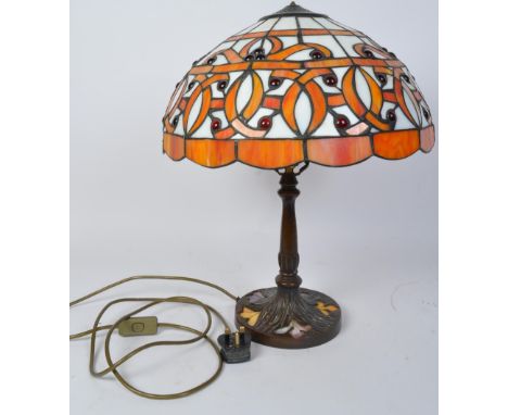A large vintage 20th century Tiffany manner lamp in the Art Nouveau style. The lamp having domed shade of orange and white gl