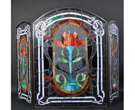 An early 20th century stained leaded glass triptych fire screen having variety of colour glass and lead in Art Nouveau design
