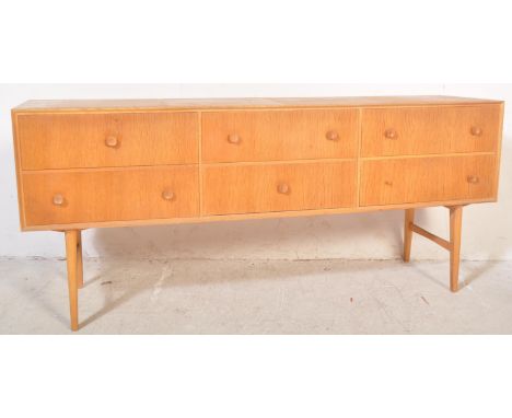 A vintage retro mid 20th century light teak sideboard credenza having three banks of two drawers, each with concave circular 