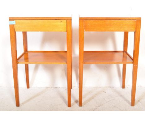 A pair of vintage mid 20th Century air ministry bedside tables. The tables having formica tops raised on tapering square legs