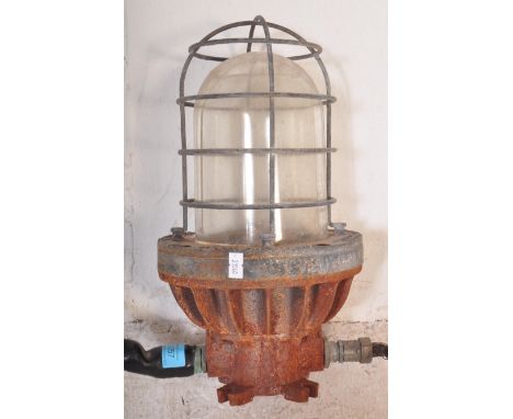 A retro vintage mid 20th Century wall mounted industrial factory warehouse bulk head light. Glass light shade of dome shape p