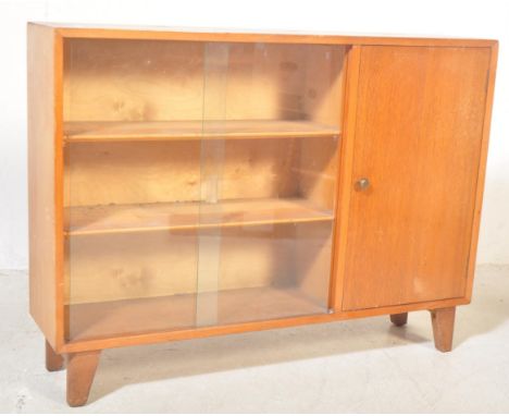 Lebus - A vintage retro mid 20th century teak glazed display cabinet bookcase having twin sliding glass doors opening to reve