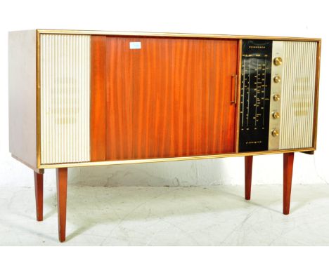 A retro vintage mid 20th century walnut veneer Ferguson stereogram sideboard. The stereogram having twin tambour roll doors o