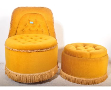 A 20th century vintage circular button back boudoir armchair raised on castors, covered in a velour type fabric with fringes.
