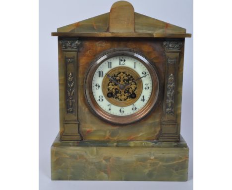 A 19th century French green and brass onyx mantel striking clock. Of&nbsp;architectural form with an arched and flared top, w