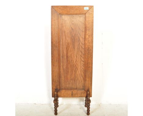 A 1930s William &amp; Mary revival upright tall panel oak fire / discretion screen. The panelled rectangular screen raised on