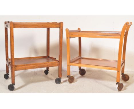 Two retro vintage 20th century oak drinks trolleys on castors. The lot to include a metamorphic oak trolley with removable tr
