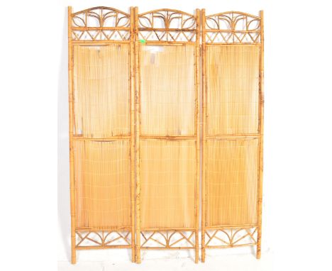 A vintage retro mid 20th century circa. 1970's bamboo folding dressing screen room divider. The screen being three fold with 
