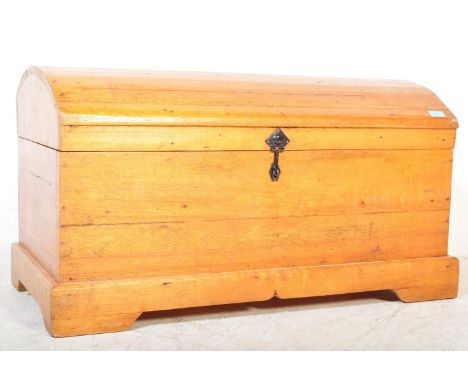 An early 20th Century pine dome topped trunk chest.&nbsp;The blanket box having a domed top, lock to front and raised on a pa