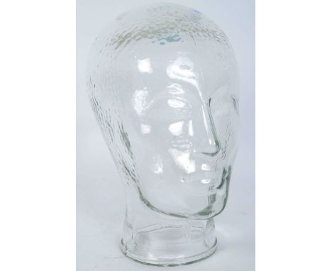 A vintage 20th century clear glass milliners mannequin pressed glass head having moulded features and dappled effect to top. 