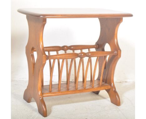 Ercol - A vintage retro late 20th century Ercol light elm coffee table having rectangular top over magazine rack with slanted