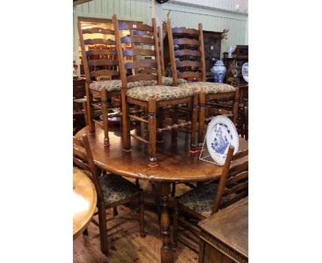 Large oval oak dining table and eight ladder back chairs