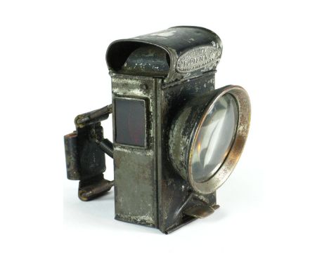 *'Eddystone'. An oil-powered safety bicycle lamp by Powell and Hanmer,  with red side glasses and a double convex front glass