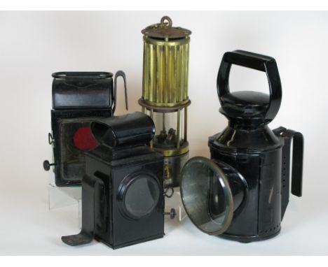 *Four oil-powered lamps. A Premier Lamp and Engineering Co. miner's safety lamp,  having a threaded oil reservoir, hand contr