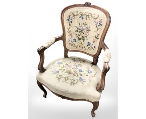 A continental carved beech salon armchair in tapestry fabric 