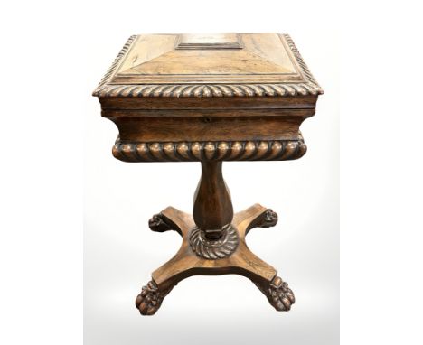 A William IV rosewood teapoy, circa 1835, the gadrooned sarcophagus top upon an octagonal tapering column, raised on a quadri