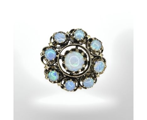A 14ct gold opal ring, set with nine cabochon Australian opals weighing 5.02ct, size L.