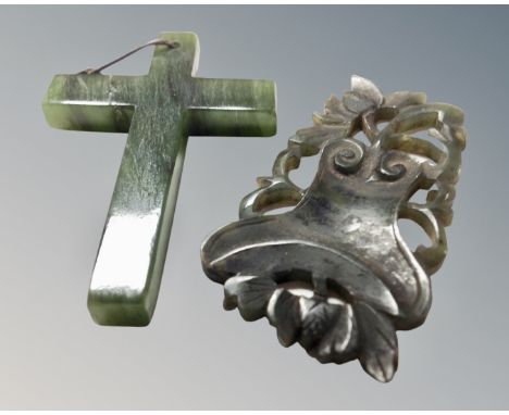 A jade crucifix pendant together with further jade carving.