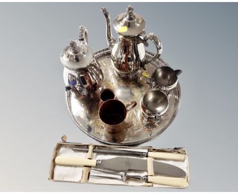 A four piece silver plated tea service on tray together with two pieces of copperware and a stainless steel three part carvin