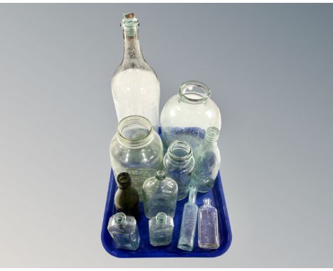 A tray containing vintage glass bottles including Boots the Chemists, Dinneford's Magnesia, John Smiths Brewery Ltd. etc.