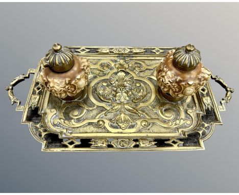 A Victorian cast brass and ceramic desk stand with two inkwells, width 37cm. 