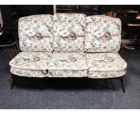 An Ercol stained elm three seater settee (width 173cm)