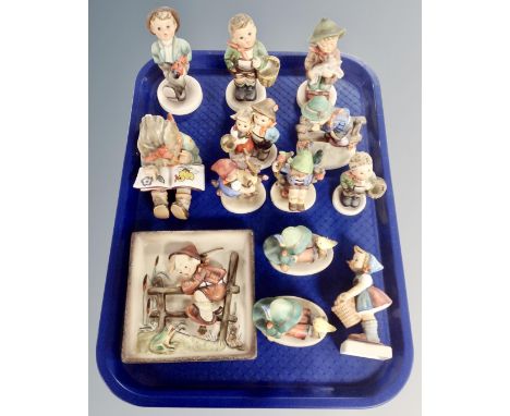 A collection of Goebbel Hummel figures and a Hummel plaque.