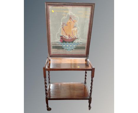 A 20th century oak two-tier tea trolley together with tapestry fire screen 