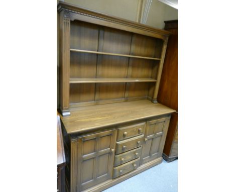 Carved oak sideboard with 4 drawers flanked by single door cupboards with a 2 shelf dresser top 