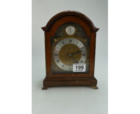 Tempus Fugit oak cased mantle clock by Elliot.  Height 20cm. 