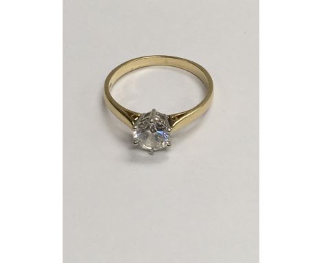 A 14 ct gold ring inset with A single C Z stone . Size Q .