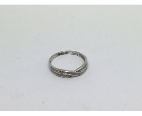 An 18ct white gold Crossover ring Set with diamonds approx 0.15ct. Size o approx weight 2g