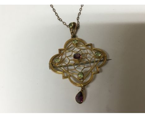 A vintage 9carat gold brooch pendent set with amethyst and green peridot. With a 9carat gold chain attached.