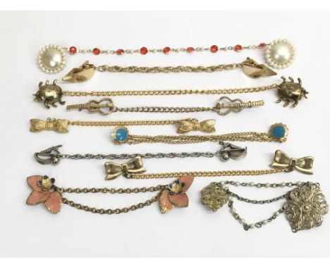 A collection of ten vintage cloak fasteners of varying designs