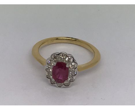 An 18ct yellow gold oval -cut ruby and RBC diamond cluster ring. Ruby 0.80ct. Diamonds 0.40ct. Ring size N