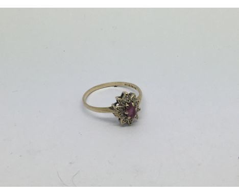 A 9ct gold ring set with a ruby and diamond cluster. Size o/p approx weight 1.7g