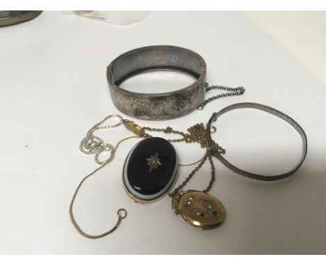 A Silver bangle antique mourning brooch a gold front and back locket and other oddments. (a lot)