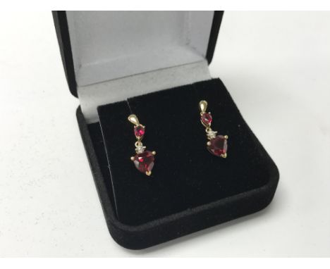 A pair of 9ct gold ruby and diamond earrings.