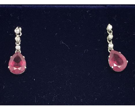 A pair of 18ct white gold ruby and diamond drop earrings with butterfly backs, boxed. Rubies 2.00ct. Diamonds 0.08ct