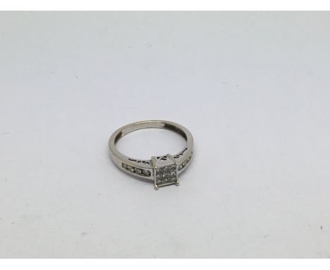 An 18ct white gold ring set with baguette cut and princess cut diamonds approx 0.30ct. Size m approx weight 2.3g