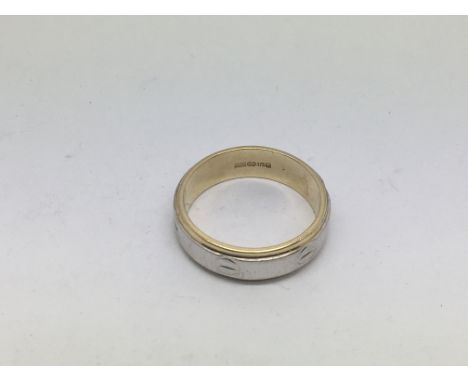 A 9ct gold Cartier style white and yellow gold ring, approx 5.9g and approx size S.