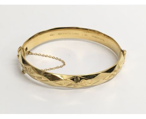 A 9ct gold metal cored bangle